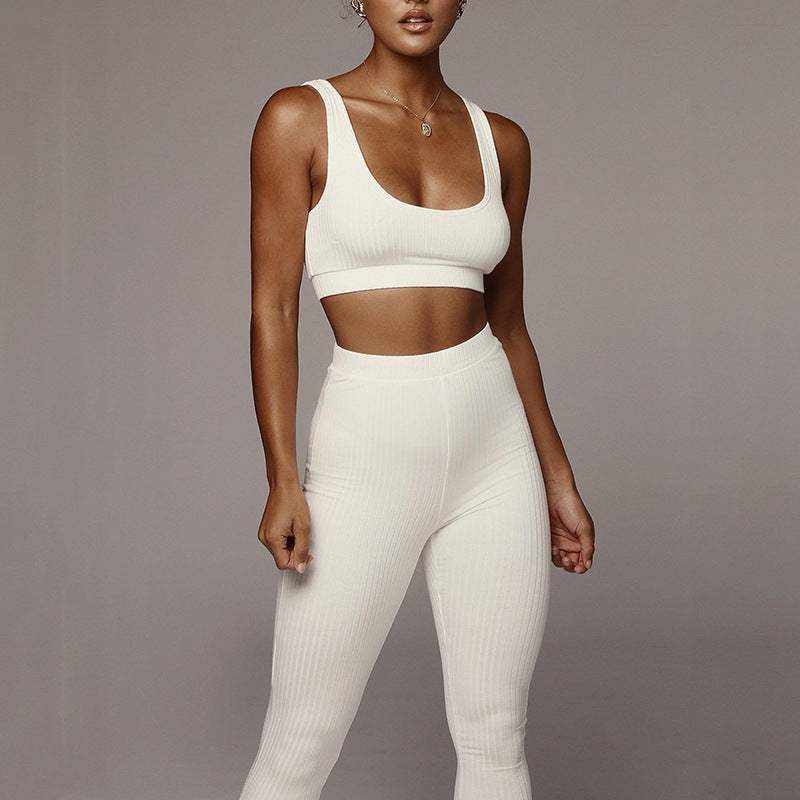 woman wearing white Hip Lift yoga Suit against gray background