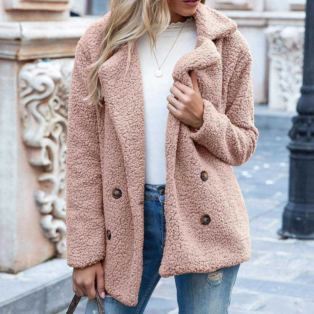 woman wearing beige fluffy coat winter jacket with blue jeans outdoors