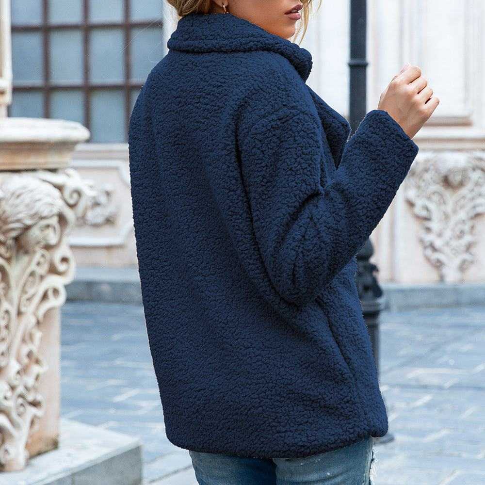 Woman wearing navy blue fluffy coat winter jacket outdoors in stylish casual outfit