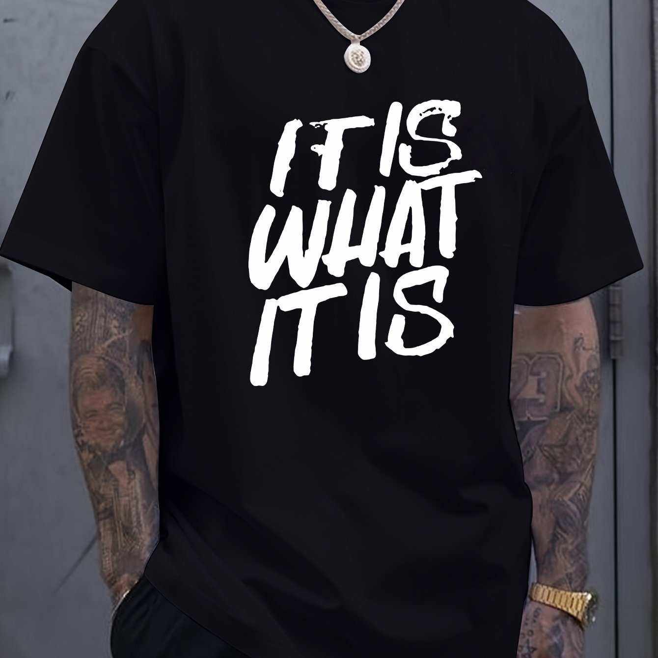 Black T-shirt with bold white text saying "IT IS WHAT IT IS"