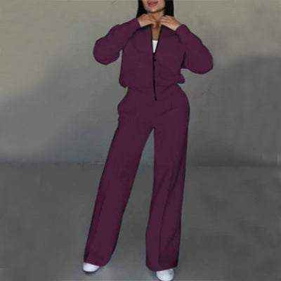 Woman wearing stylish purple leg pants two-piece set with zip-up top and wide-leg pants