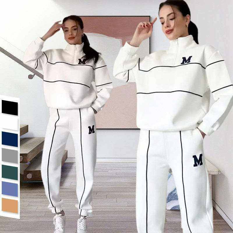Women wearing white 2 Piece Lounge Hoodles set with black piping and "M" logo, styled for casual comfort.