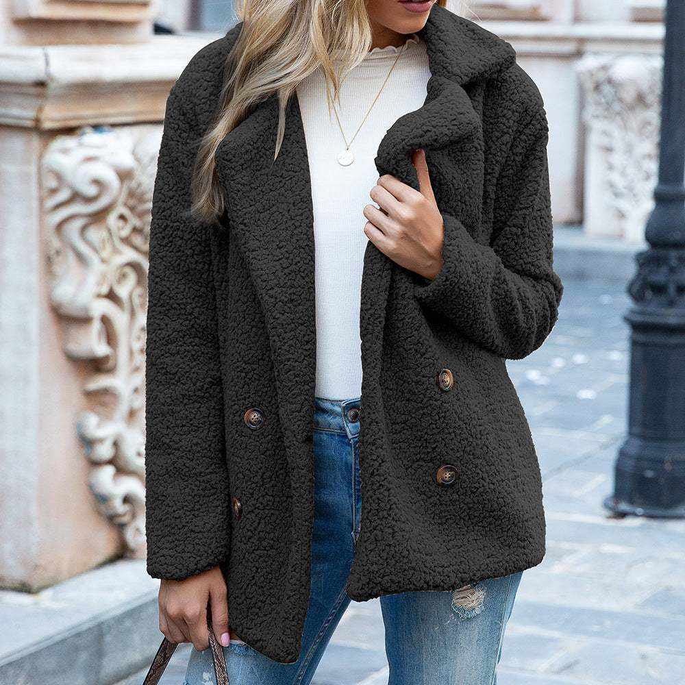 woman wearing black fluffy winter coat jacket with buttons outdoors