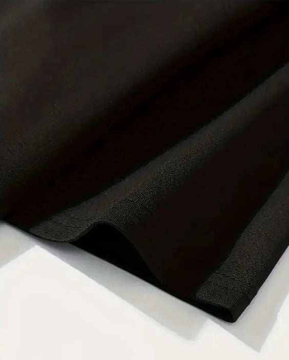 Close-up of black "I'm Thinking" T-shirt fabric made of 95% polyester and 5% spandex with short regular sleeves and printed retro style design.