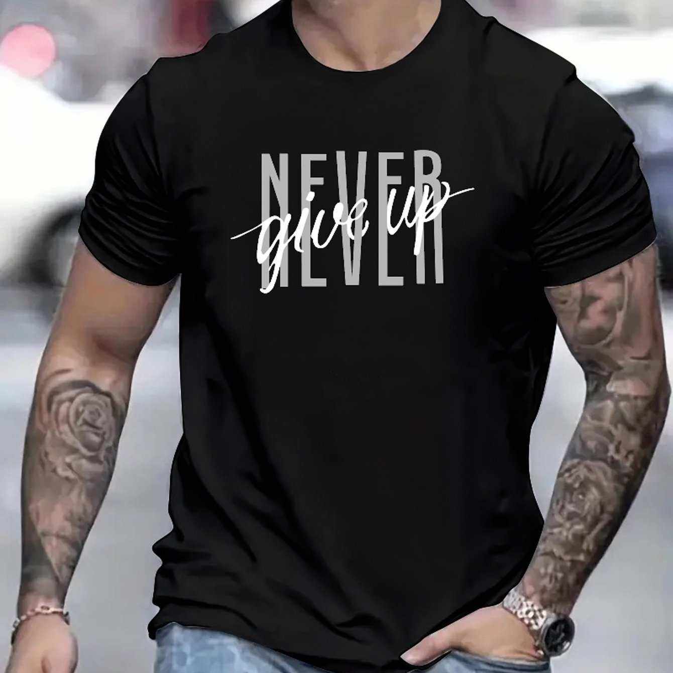 Black Never Give Up printed t-shirt worn by a tattooed man