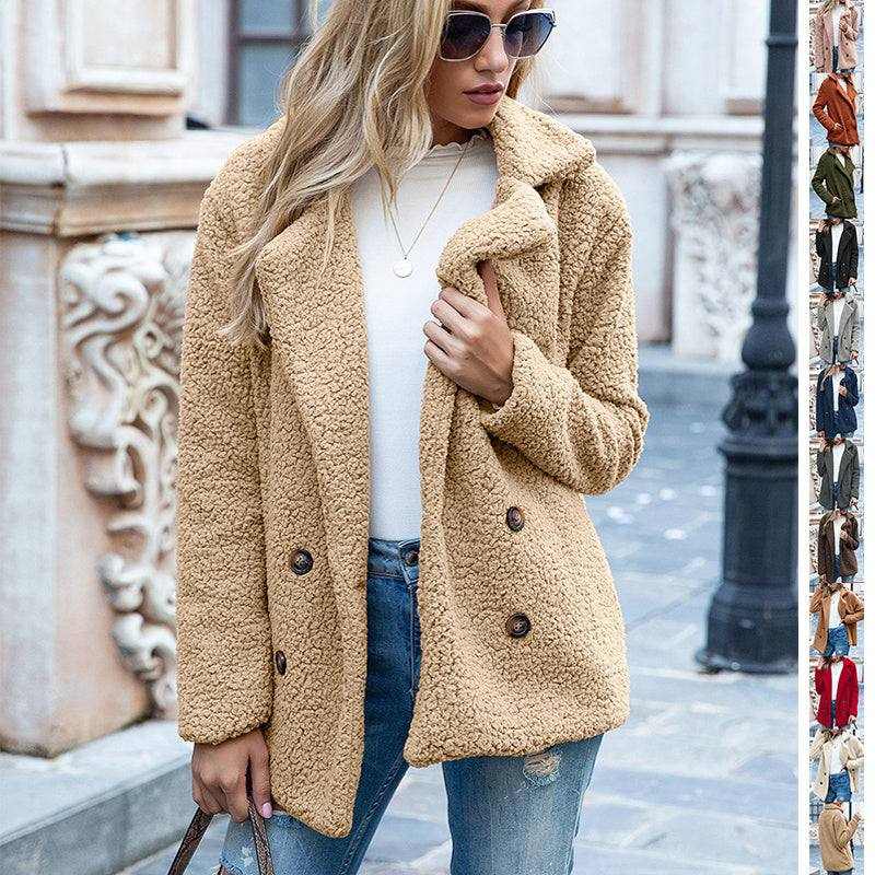 Woman wearing beige fluffy coat winter jacket with sunglasses and blue jeans outdoors