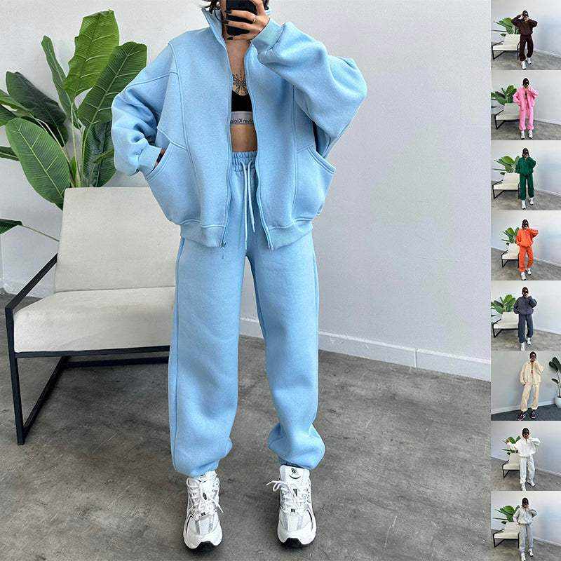 Woman wearing light blue Jogger Tracksuits LX with zip-up jacket and drawstring pants in minimal room setting