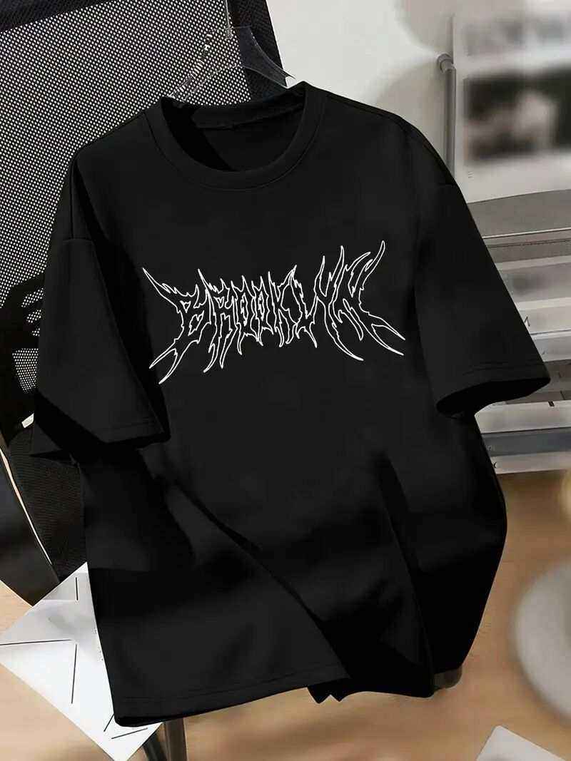 Black Brooklyn T-shirt with white graphic text design on front laid flat on a chair.