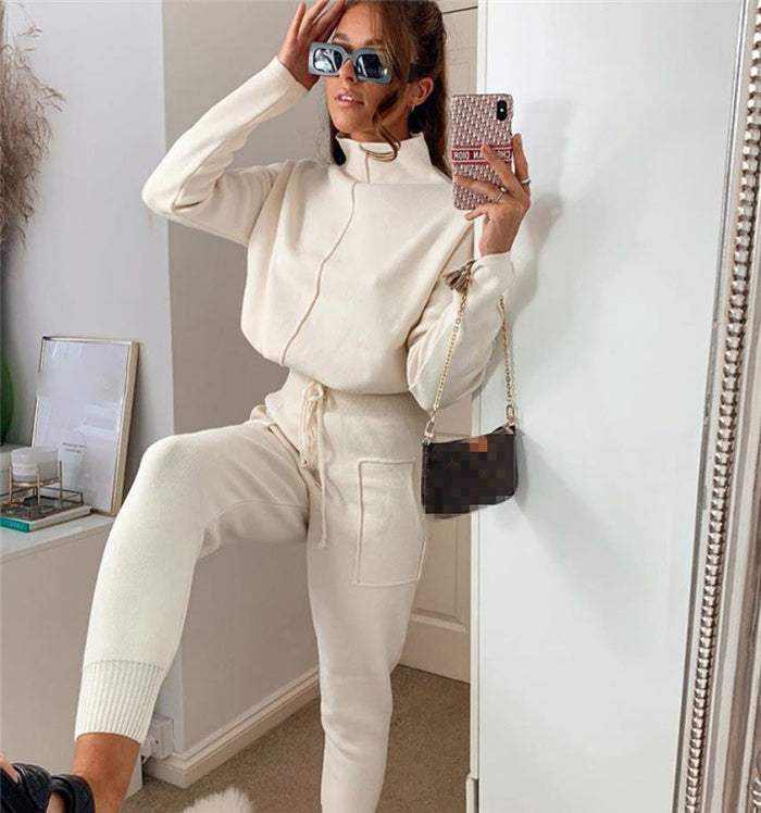 Woman wearing European Sportswear LX cream cozy tracksuit and sunglasses taking mirror selfie