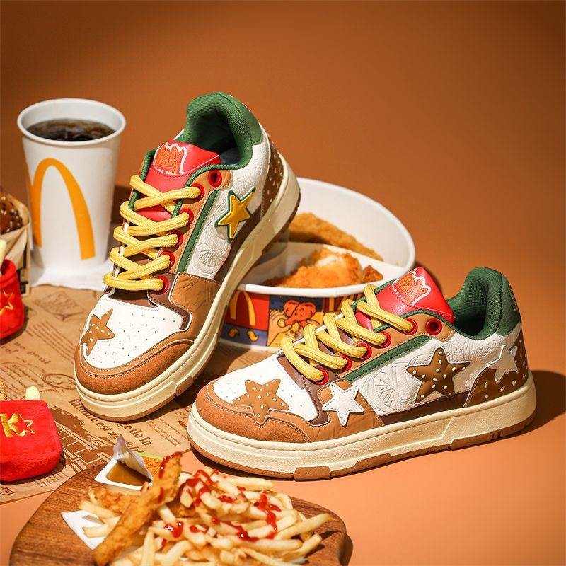 Colorful platform sneakers with star designs and yellow laces on a table with fast food background