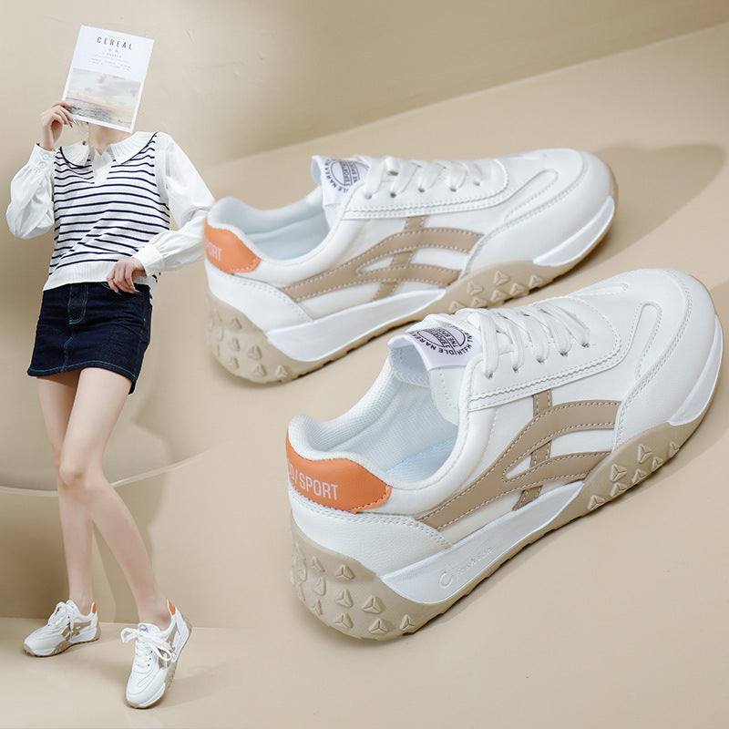 Leisure Street Shot white and beige casual sneakers with orange heel detail worn by model