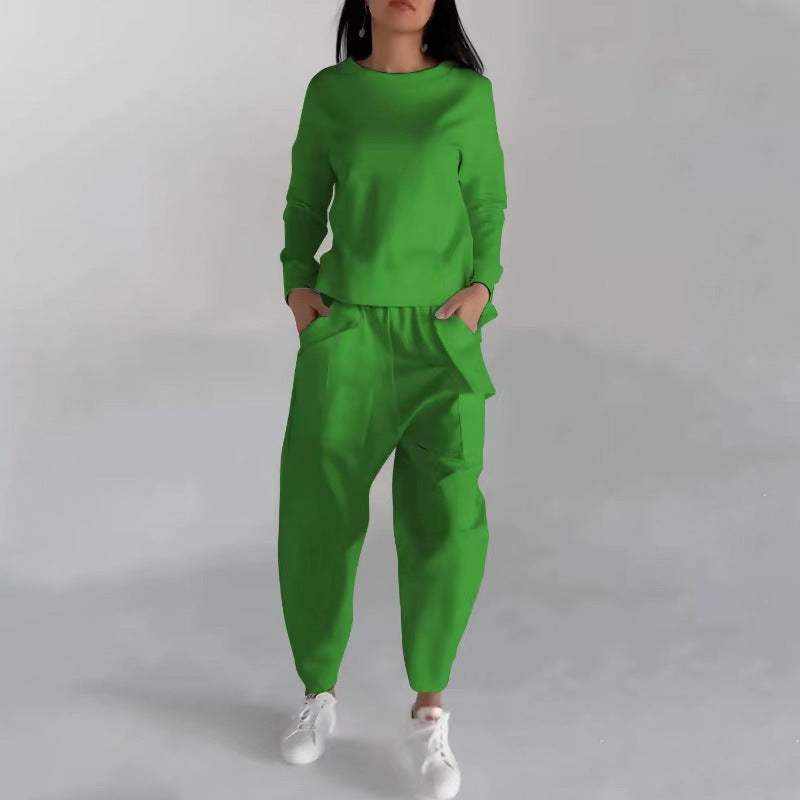 Green fashion sweatshirt top and matching pants outfit with white sneakers on model