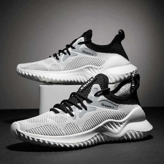 Lightweight black and white Flying Woven Shoes with breathable mesh upper and textured sole displayed on a gray background