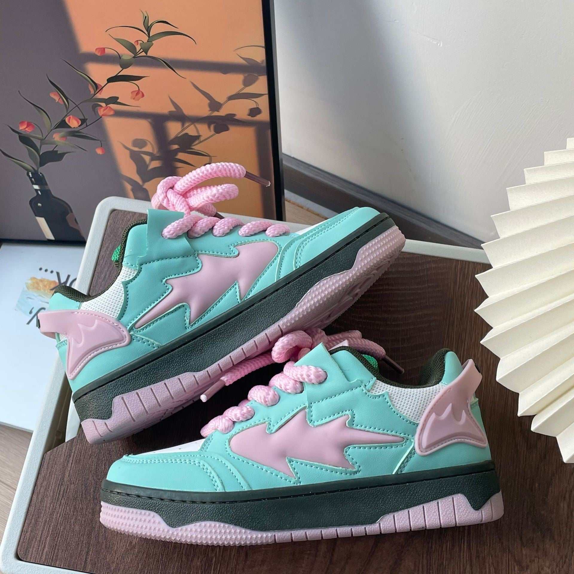Mint green and pink distressed sneakers with front tie-up and anti-slip sole