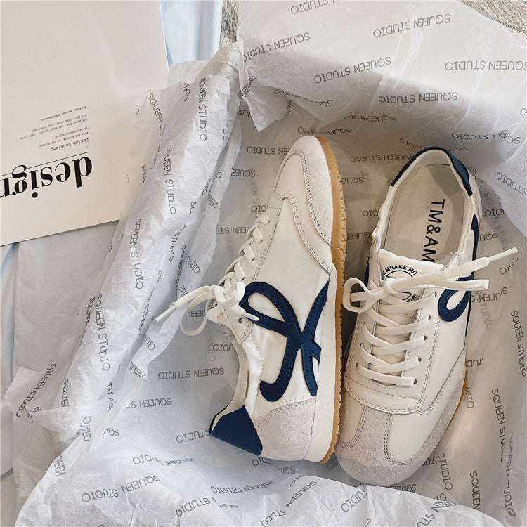 Classic Sneaker LX white casual shoes with navy blue accents and gum sole