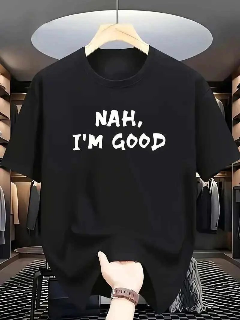 Black T-shirt with white bold text "Nah, I'm Good" printed on front hanging on wooden hanger in modern closet
