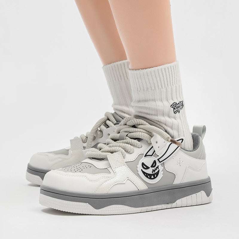 Beige and gray low top couple sneakers with white mesh lining and flat comfortable sole, casual color matching design.