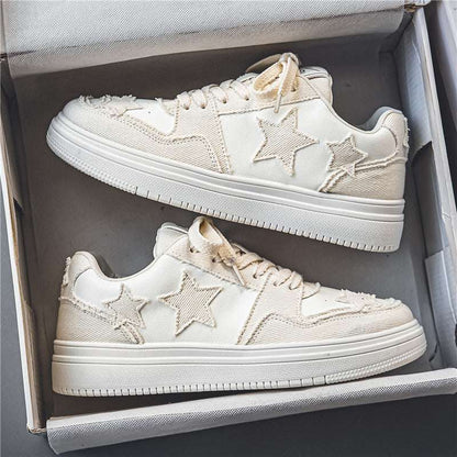 Pair of white Stars Versatile Sneakers with stitched star designs in a shoebox.