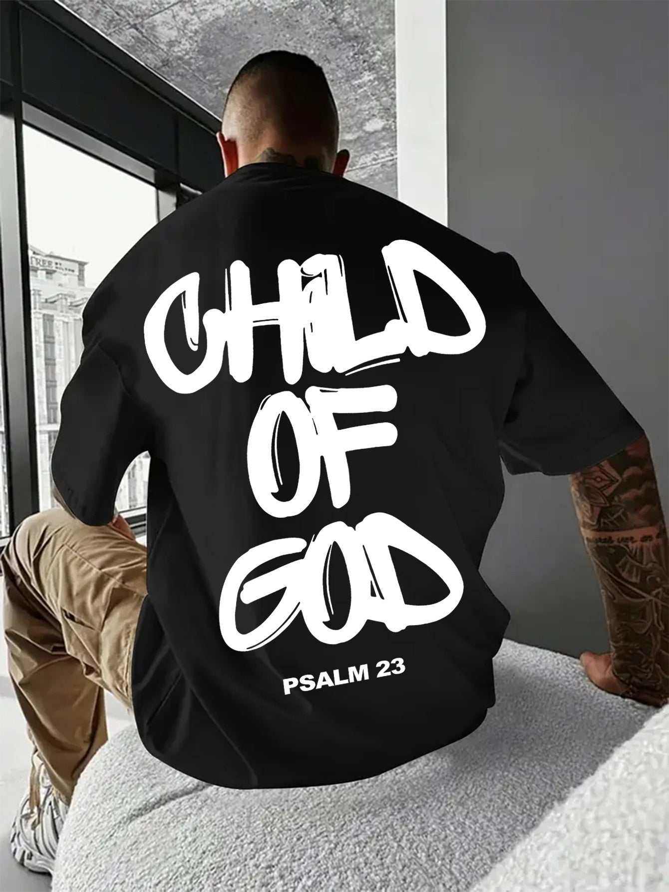 Black short-sleeved retro Child Of God T-shirt with bold white Psalm 23 print on the back.