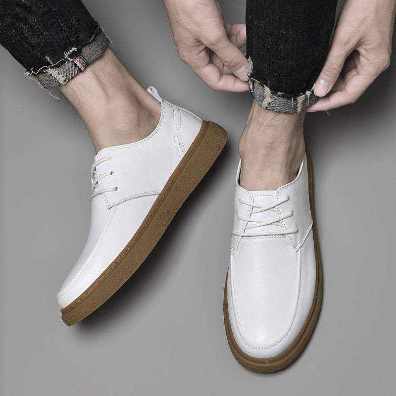 White cowhide sneakers LS with brown soles worn with rolled-up black jeans