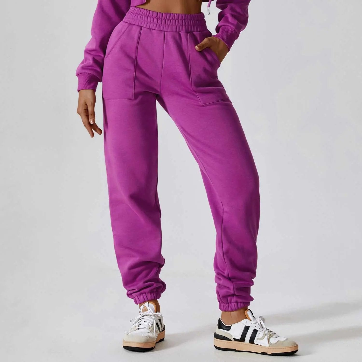 Purple Polar Velvet Sweatpants with elastic waistband and cuffs worn with white sneakers