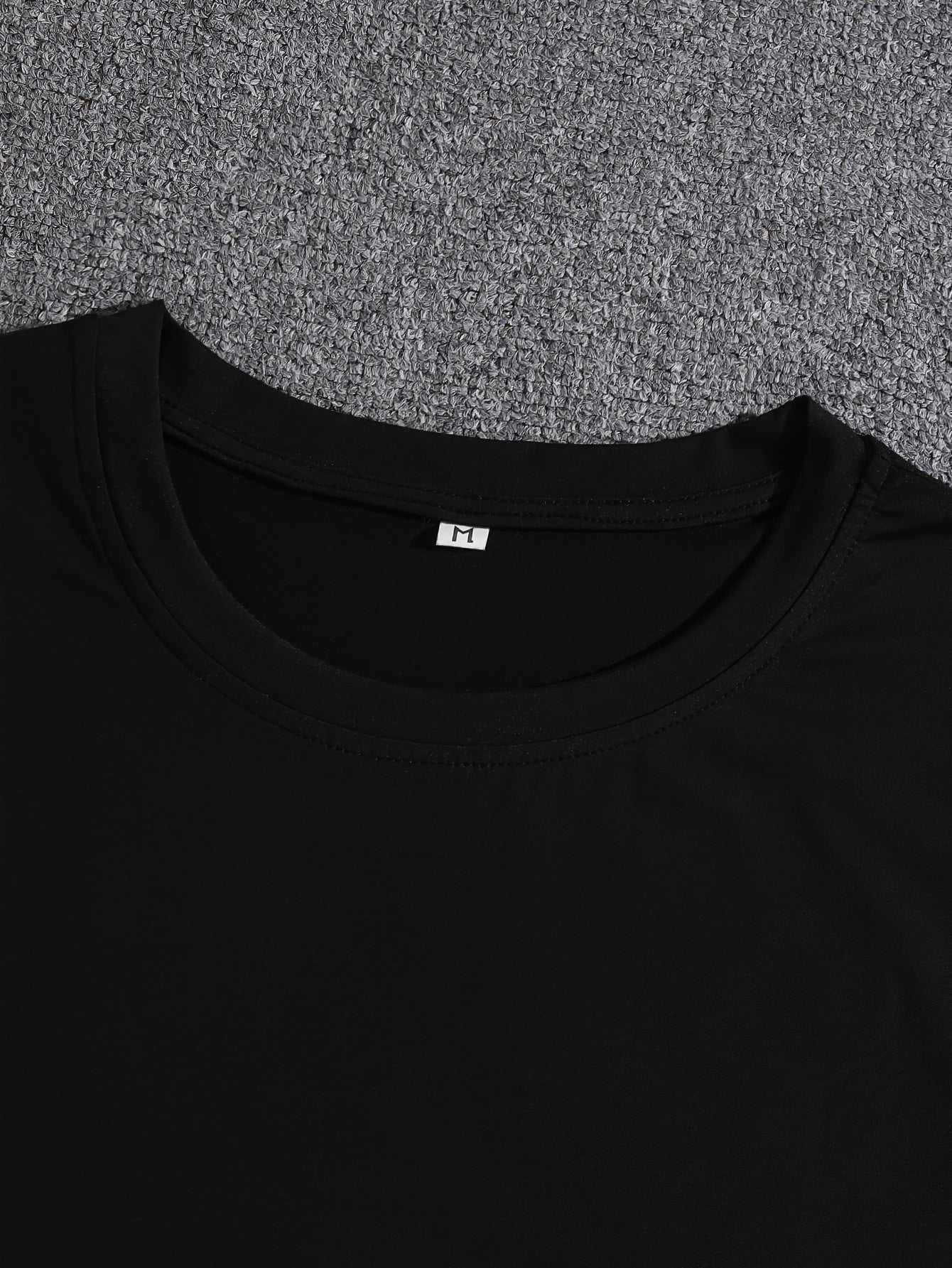 Black Creative Summer T-shirt with round neckline and short regular sleeves on gray background
